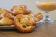 Auf einem Teller liegen Neujahrsbrezeln. Eine Brezel ist nach unten gerutscht und zeigt nach vorne.