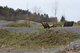 Außenansicht des Dirtparks für Mountainbiker. Hügellieges Gelende und Schrottenpisten.